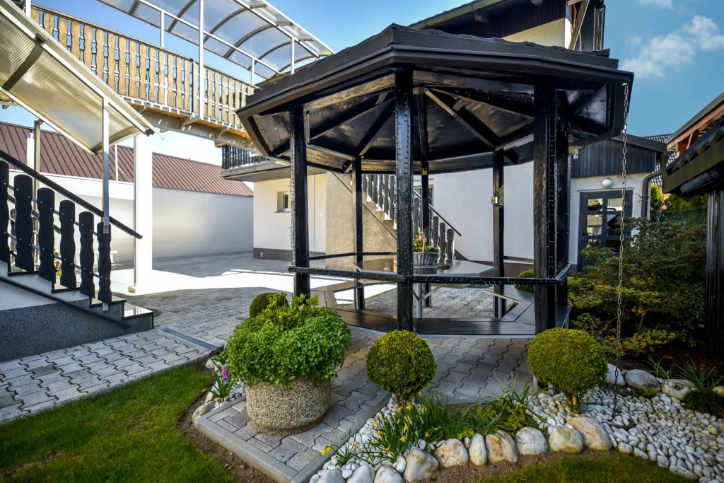 Garden pavilion in front of SEDAMI apartment entrance with private parking space monitored by security camera in Maribor